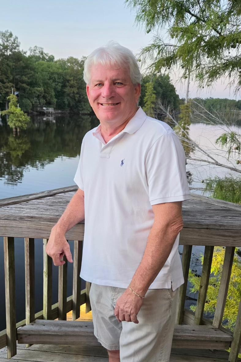 Mark Booth standing on a dock at the lake